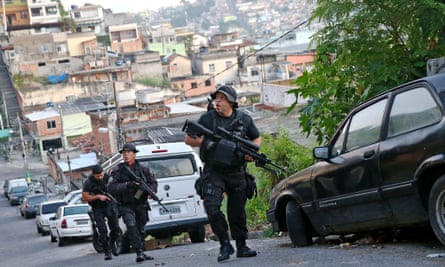 Officers from the CORE police special forces patrol during an operation to search for fugitives in a favela in Rio de Janeiro, Brazil. 