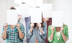 students holding paper in front of their faces