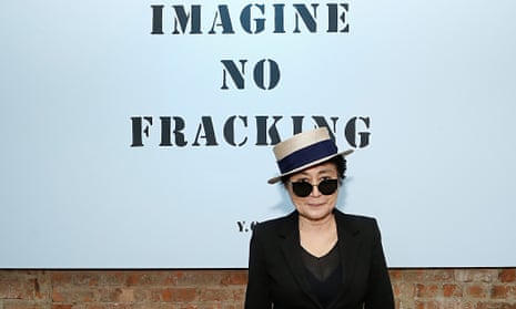 Yoko Ono in a hat and sunglasses in front of a sign reading Imagine No Fracking Installation