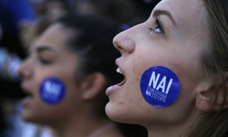 A supporter of the yes vote in the upcoming referendum at a rally outside the Greek parliament on Tuesday. The sticker reads: ‘Yes to Greece, yes to euro.’