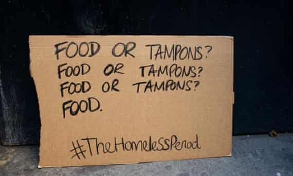 Cardboard sign reading 'food or tampons'