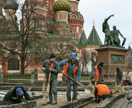 Migrant workers pave Red Square outside St Basil's Cathedral.