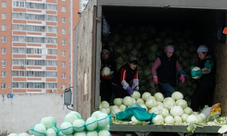 Tajik migrant workers unload cabbages at a vegetable market in the Moscow suburbs.