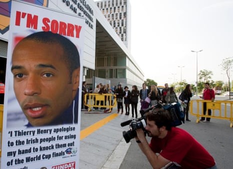 A cameraman films a poster of Thierry Henry in Barcelona in 2009.