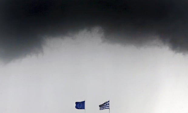 A Greek national flag and a European Union flag flutter under storm clouds in Athens.