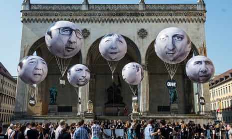 Activists decorate balloons with the faces of, left to right, Shinzo Abe, François Hollande, Matteo Renzi, Angela Merkel, Stephen Harper, David Cameron and Barack Obama during a protest against the G7 summit on Friday in Munich.