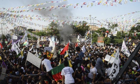 HDP supporters look at smoke from an apparent explosion during a rally in Diyarbakir on Friday.