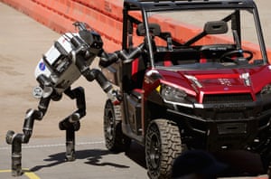 The 125kg RoboSimian, developed by Jet Propulsion Labs at the California Institute of Technology, climbs out of a Polaris vehicle after driving through obstacles.