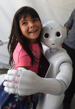 Yaretzi Bernal, six, gets a hug from Pepper the ‘social’ robot.