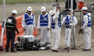 The University of Hong Kong team works to pick up its robot, Atlas, after it falls during the first stage.