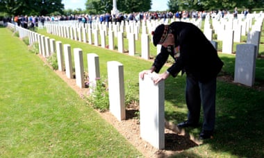 Neville Foot from Bury, Lancashire, at the grave of a comrade from the Scottish Horse Regiment at Bayeux war cemetery.