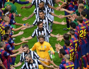 Juventus players recieve a guard of honour from the Barcelona team as the go up to receive their runners-up medals.