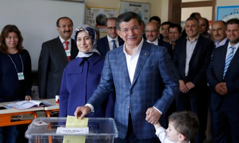 The Turkish prime minister, Ahmet Davutoğlu, casts his ballot next to his wife, Sare, at a polling station in Konya during the parliamentary election.