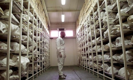 A forensic expert inspects bags containing bodies of people believed killed in the Srebrenica massacre: if it had been available, the eyeWitness to Atrocities app may have helped in collecting evidence against those responsible.