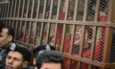 Defendants celebrate at a court in Cairo following the acquittal of 26 male men accused of "debauchery" after they were arrested in a aid on a bathhouse in the Egyptian capital.
