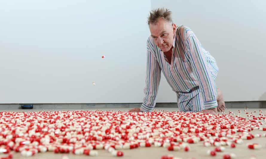 Adrian Searle contemplates the red and white capsules that rain, one every three seconds, from the ceiling.