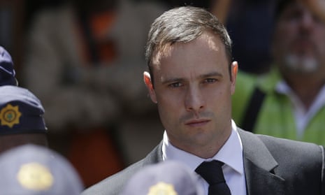 Oscar Pistorius is escorted by police officers as he leaves the high court in Pretoria, South Africa, last October.