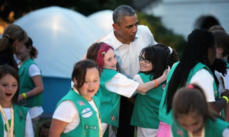 Barack Obama fields a group hug from some of the Girl Scouts.