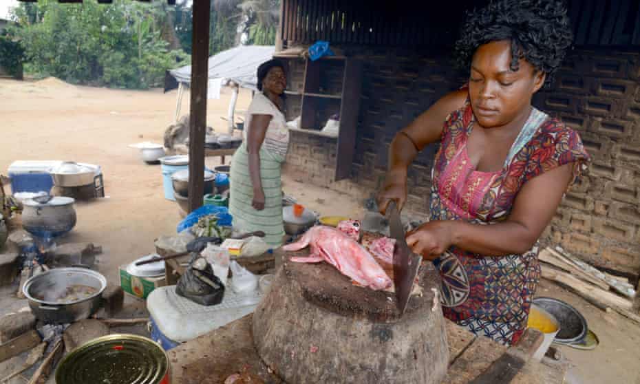 A woman cuts rabbit meat at a "maquis," a small African restaurant, in Kobakro, outside Abidjan, which used to serve bush meat, on April 8, 2014.  AFP PHOTO / ISSOUF SANOGOISSOUF SANOGO/AFP/Getty Images