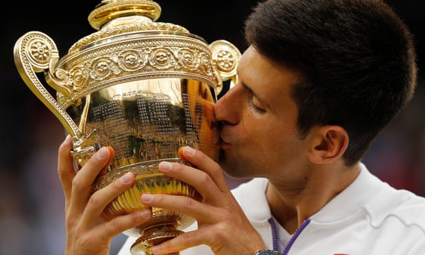 Novak Djokovic kisses the trophy after his victory over Roger Federer.