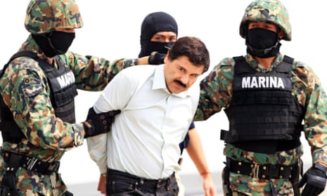 Mexico's most wanted . . . the Mexican military holding drug baron Joaquin Guzman in 2014. He has escaped from a maximum-security prison for the second time.
