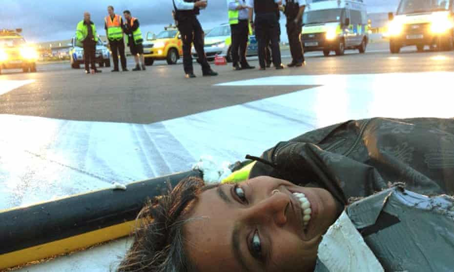 A climate change activist from Plane Stupid, on the north runway at Heathrow airport.