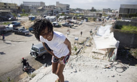 Linda Desammlouis, 22, stands on the rooftop of the earthquake-damaged building where a fluctuating population of homeless youth sleep in downtown Port-au-Prince.