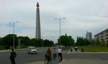 North Koreans cyclists use the new lanes, with the 170m Juche Tower behind them. Cycle ownership has risen by 50% in recent years, experts say.