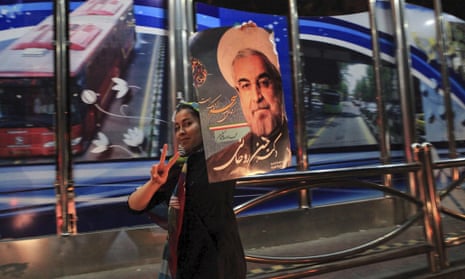 A supporter of Hassan Rouhani celebrates his victory in Iran's presidential election along a street in Tehran on 16 June 2013.