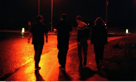 Teenagers walking in the street at night