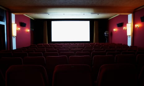 An illuminated screen in an empty cinema theatre