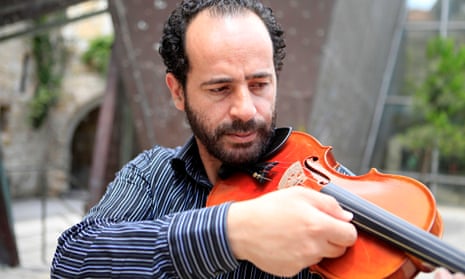 Ramzi Aburedwan playing the viola at his music school in Ramallah