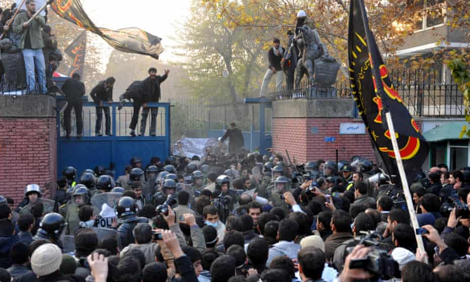 Protesters storm a security gate as they break into the British embassy in Tehran in 2011