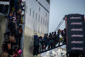 Passengers disembark from a ship in eastern Java