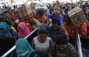 Passengers carry belongings in Jakarta