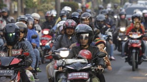 People ride motorcycles in Indonesia