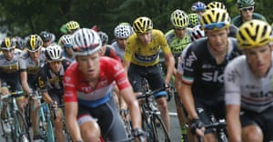 Britain’s Chris Froome, wearing the overall leader’s yellow jersey, rides in the pack