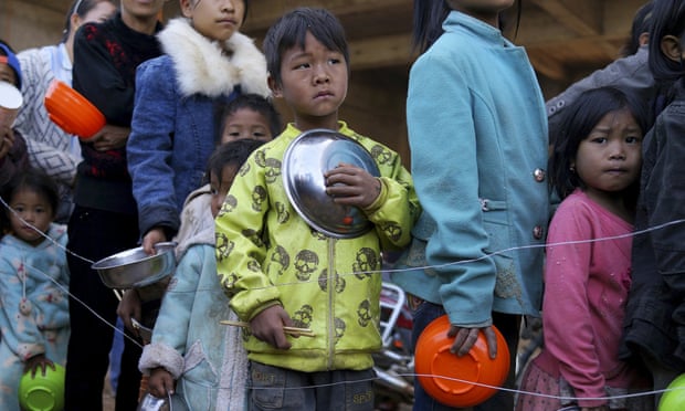 Children queue for food at a refugee camp on the Burma-China border. 