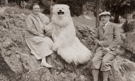Smile, please … a German couple pose with a furry bear.