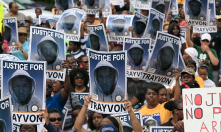 Protesters hold signs during a march and rally for Florida teenager Trayvon Martin in 2012.