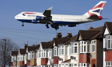 A British Airways 747 aircraft flies over roof tops as it comes into lane at Heathrow Airport in west London.