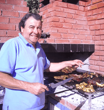 Elvio attending to the BBQ. 