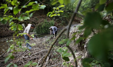 Hajra Catic (right) and Edmin Jakubovic search for the remains of her son at the location where Jakubovic last saw him wounded.