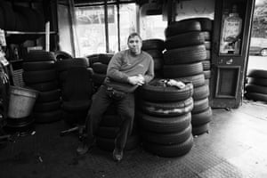 <strong>Chatsworth Road, Hackney, 2010</strong> Steve sits on his stock of tyres in the shop that he and his family ran for more than 50 years. It smelled of rubber and the Michelin man in the window was covered in dust. The shop closed on October 2 2010, shortly after I took this photograph