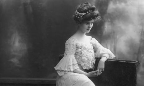 Actress Carol McComas wearing a dress with ruched sleeves, a lace sweeping skirt and bustier in the style of the House of Worth, circa 1900.