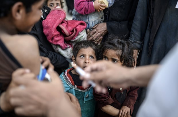 Vaccines are administrated to Syrians children before entering Turkey, June 2015.