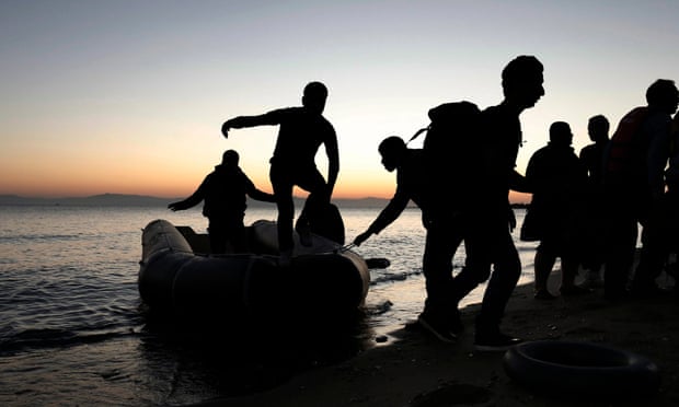 Syrian refugees disembark from a dinghy on the Greek island of Kos.