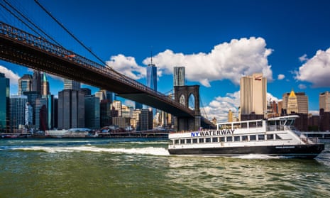 The East River Ferry, Brooklyn bridge and Manhattan skyline seen from Brooklyn, New York.