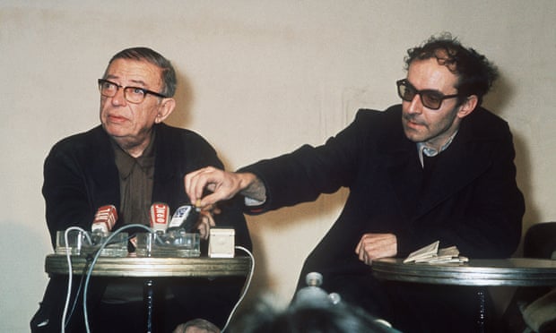 PARIS - FEBRUARY : French existentialist philosopher and writer Jean-Paul Sartre (L,1905-80) and French film director Jean-Luc Godard, one of the leaders of French “nouvelle vague” cinema, answer the media in February 1971 in Paris.