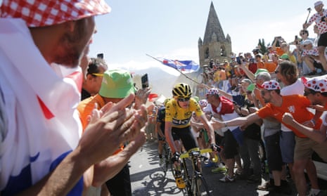 Britain's Chris Froome, wearing the overall leader's yellow jersey, climbs towards Alpe d'Huez.